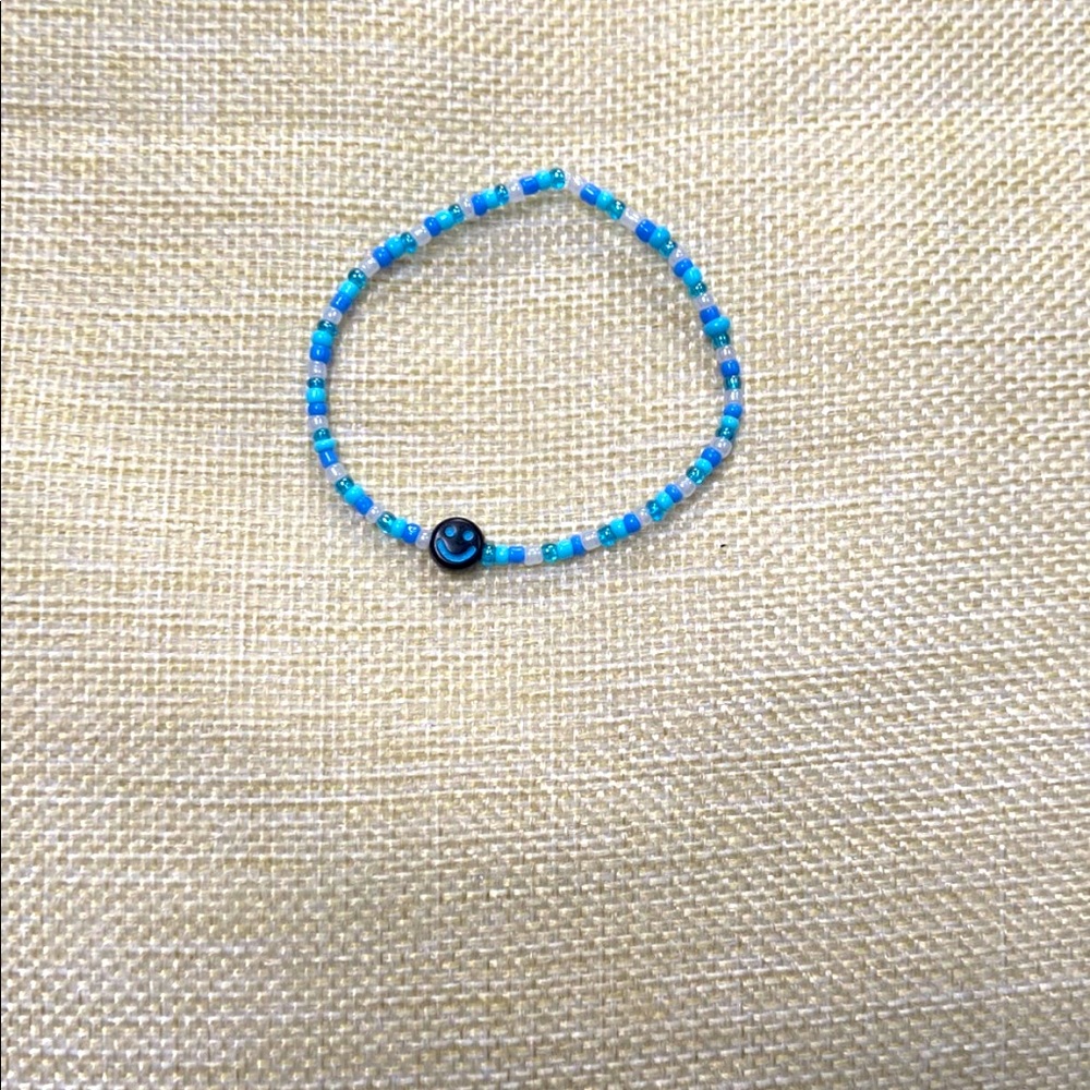Blue smiley bracelet.